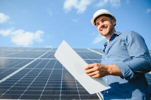 Solar power plant. Engineer on a background of photovoltaic panels. Science solar energy. photo