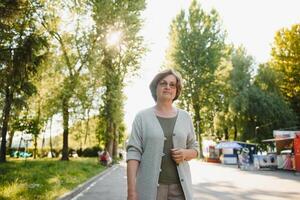 Smiling senior woman having recreation in park. photo