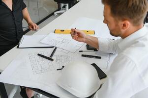 Team of architects people in group on construciton site check documents and business workflow photo