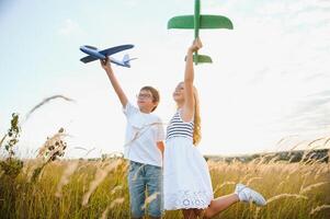 children play toy airplane. concept of happy childhood. children dream of flying and becoming a pilot. photo