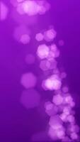 verticaal video - onscherp bokeh lichten abstract achtergrond. deze elegant Purper beweging achtergrond animatie met zeshoekig lens vervagen bokeh deeltjes is vol hd en een naadloos lus.