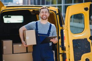 The courier brought the delivery of the box to the client. Courier service employee in uniform. photo