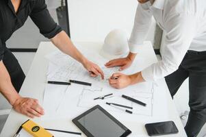 Team of architects people in group on construciton site check documents and business workflow photo