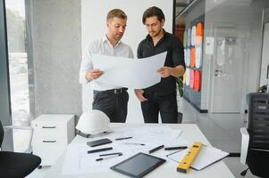 Architect concept, Architects working with blueprints in the office photo