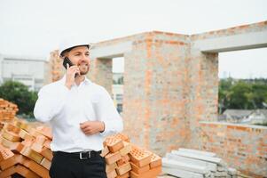 Engineering Consulting People on construction site holding blueprint in his hand. Building inspector. Construction site check drawing and business workflow of new building. photo