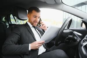 Attractive elegant happy man in good car photo