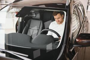 Man buying a car at a showroom photo