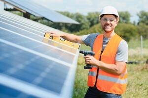 Worker installing solar panels outdoors photo