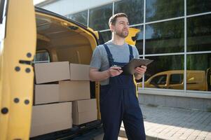 The courier brought the delivery of the box to the client. Courier service employee in uniform. photo