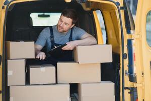 The courier brought the delivery of the box to the client. Courier service employee in uniform. photo