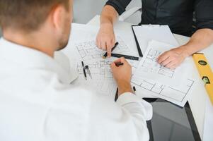 Team of architects people in group on construciton site check documents and business workflow photo