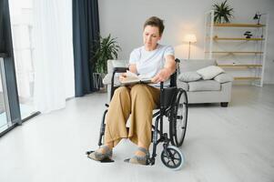 middle aged woman sitting on wheelchair photo