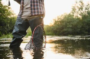 Trout fishing in the mountain river photo