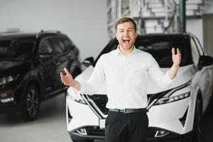 Happy customer just bought a car at car dealership photo