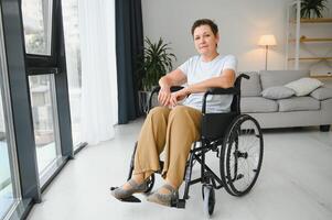 middle aged woman sitting on wheelchair photo