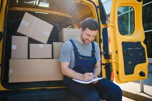 The courier brought the delivery of the box to the client. Courier service employee in uniform. photo