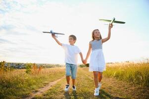 children play toy airplane. concept of happy childhood. children dream of flying and becoming a pilot. photo