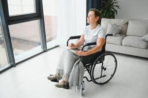 middle aged woman sitting on wheelchair photo