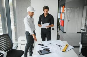 Architect concept, Architects working with blueprints in the office photo