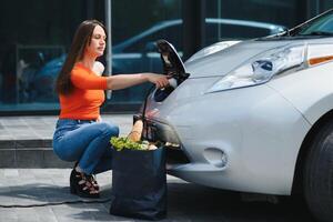 Woman is charging rental electric car photo