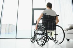 Young woman sitting in a wheelchair photo