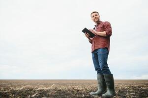 portrait of a young farmer in a field photo