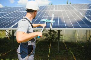 young worker cleaning solar panels. photo