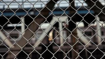 Chain link fence over railway track photo