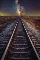 ferrocarril pista con lechoso camino en noche cielo. foto