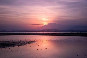 Dramatic sunset over mountain and sea. photo