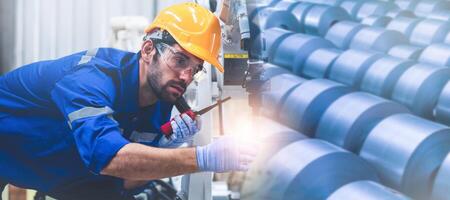 Engineers mechanic using computer controller Robotic arm for welding steel in steel factory workshop. Industry robot programming software for automated manufacturing technology. photo