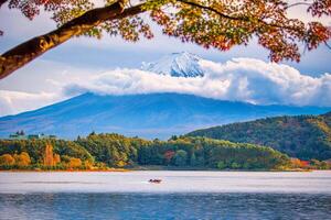 Mt. Fuji on blue sky background with autumn foliage at daytime in Fujikawaguchiko, Japan. photo