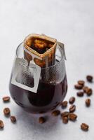 Drip Coffee Bag in a Glass Cup photo