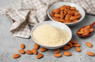 Fresh almond flour in a  bowl and almonds photo