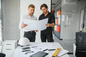 Architect concept, Architects working with blueprints in the office photo