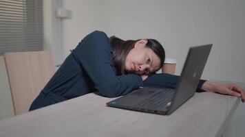 Close up view of overworked woman, tired from work, falls asleep at desk with laptop Unmotivated office worker lying on the desk, bored, wants to rest, insomnia concept. video