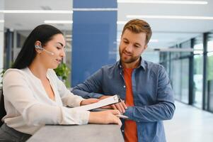 Excellent service. Nice friendly woman talking to the client while standing at the reception. photo