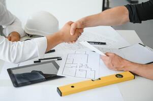 Team of architects people in group on construciton site check documents and business workflow photo