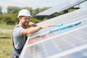 young worker cleaning solar panels. photo