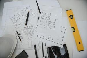 architect design working drawing sketch plans blueprints and making architectural construction model in architect studio,flat lay. photo