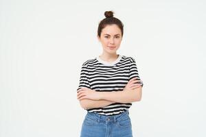 Portrait of young stylish woman, 25 years old, looking upbeat and motivated, posing for photo against white background