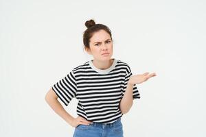 Image of frustrated woman complaining, looking puzzled, shrugging and frowning, standing over white background photo