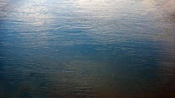 Background of the water surface of the Salzach river. Texture of water of a mountain river. photo