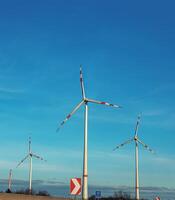 Wind farm park next to a road in Austria in sunny weather. photo