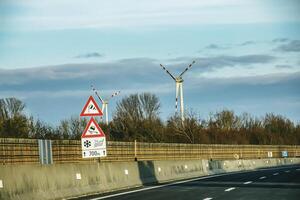 Wind farm park next to a road in Austria in sunny weather. photo