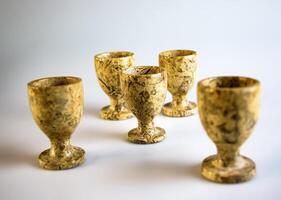 Handmade stoneware. Shot glasses made of jasper on a white background. Selective focus. photo