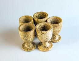 Handmade stoneware. Shot glasses made of jasper on a white background. Selective focus. photo