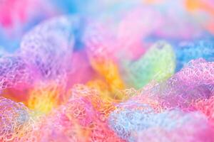 Knitted surface woolen items rainbow colored as a background. Closeup of soft multicolored knitted texture patterns. Warm winter clothes. Background textile surface with copy space for text. blurred photo