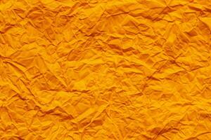 Orange crumpled paper background photo