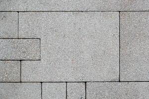 Grey brick stone street road. Light sidewalk, pavement texture photo